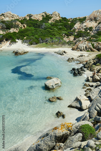 Marine landscape with turquoise waters with granite rock and wild Mediterranean vegetation on a sunny day. The Maddalena Archipelago Cala Napoletana, Sardinia, Italy.