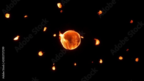 Burning fire sphere exploding and releasing glowing hot lava sparks in macro shot against pitch black dark background. Intense heat and energy concept