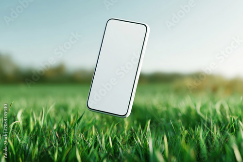 Blank smartphone screen mockup floating above lush green grass in warm sunlight