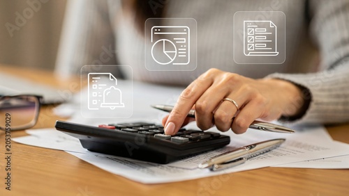Close up of woman hand using calculator for finance and tax accounting, managing budget with pen and icons, ideal for business marketing