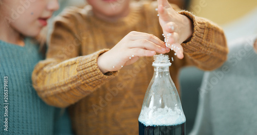 Photos Children, hands and science experiment in home with cola, bonding or teaching skill for child development