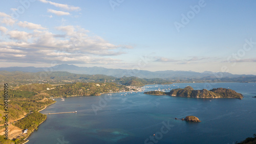 Aerial scenic view of Labuan Bajo bay with tropical islands, harbor, and mountains in Flores, Indonesia.