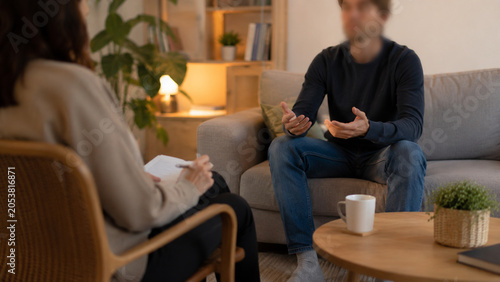 two people in calm therapy session, therapist listening