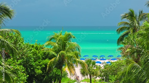 Beautiful view of Miami Beach coastline with turquoise Atlantic Ocean and tropical palm trees. USA.