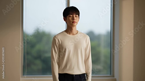 Person standing in front of a window with natural daylight