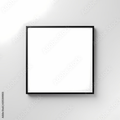 Empty square black picture frame on a textured white wall with soft light and shadow.