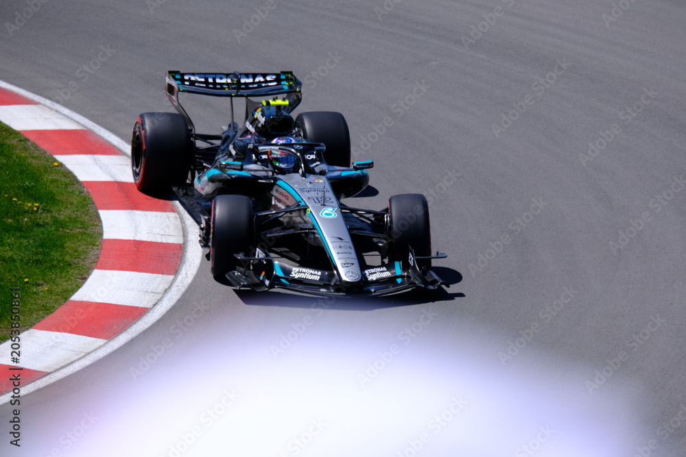 Naklejka premium May 24, 2026, Montreal, Canada, Mercedes F1 car racing through Circuit Gilles Villeneuve corner. g.