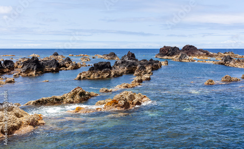 Mosteiros Natural Pools in Sao Miguel, Azores. Volcanic rock formations in the Atlantic Ocean. Clear blue waters and rugged coastline of Portugal.