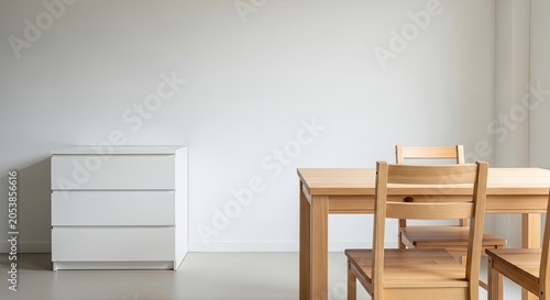 Minimalist dining area with white dresser and wooden table set