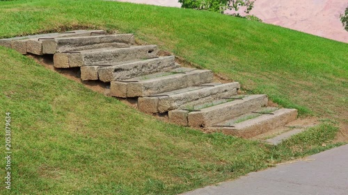 The stairs are made of concrete slabs , on the golf course