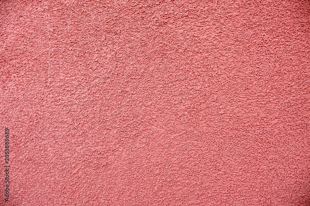 Fototapeta premium Dusty pink granular stucco wall texture.