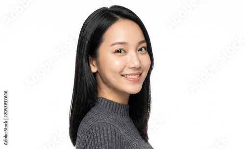 Happy smiling Asian woman with long black hair wearing gray turtleneck sweater looking at camera on white background