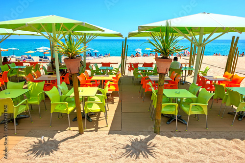  View of colourful outdoors cafe on beach in Lloret de Mar. Costa Brava, Spain