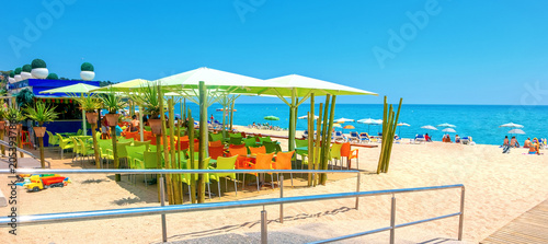 View of colourful outdoors cafe on the beach in Lloret de Mar. Costa Brava, Spain