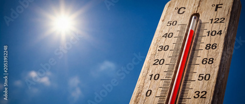 Summer heat wave, high temperature on outdoor thermometer under scorching sun. Hot weather, global warming