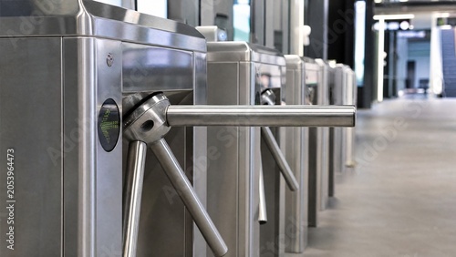turnstile. Detail of a metro station turnstile mechanism with chrome metal and clean lines. mobility guides, transit brochures, designed for transport & logistics marketing.