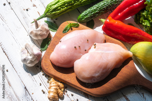 Schilderij op canvas Freshly prepared ingredients for cooking: chicken breast and vegetables