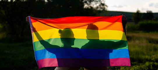 couple holding rainbow flag for pride month