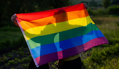 couple holding rainbow flag for pride month