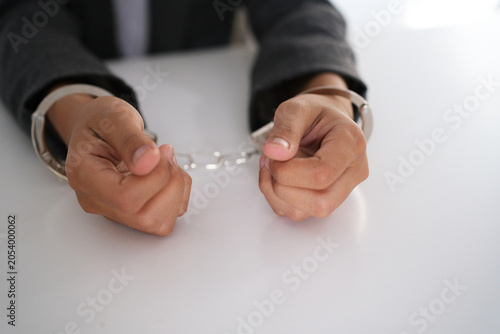 Bild auf Leinwand Business woman with handcuffs on a white background
