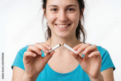 Young woman breaking a cigarette to quit smoking and choose a healthy lifestyle