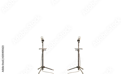 Two professional studio microphones stand symmetrically on tripod stands against a dark background This isolated minimalist setup is ready for highquality audio capture vocals music broadcast