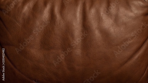 A close-up view of a brown leather surface with visible texture and wrinkles