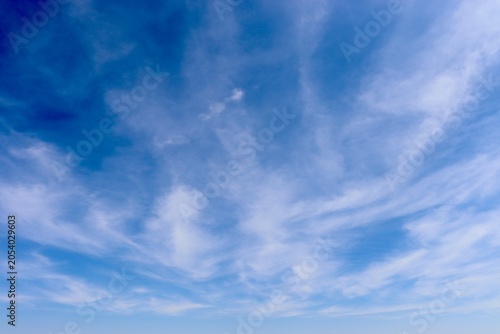 The swirling white clouds in the blue sky.