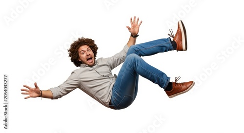 Shocked Young Man Falling Down with Surprised Expression Isolated on White Background Concept of Accident or Failure