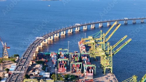 Aerial View of Docks Area Full of Containers in Rio de Janeiro City Port and The Bridge To Niteroi Crossing Guanabara Bay