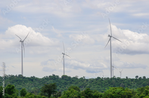 A high-quality photograph of modern wind turbines generating clean renewable energy against a beautiful sky. Symbolizing sustainable development, green technology, environmental conservation, and the 
