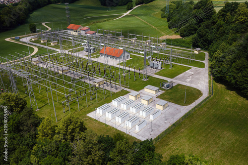 BESS installed at an electrical substation integrates renewable energy. The site shows battery units and power distribution infrastructure.