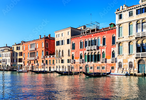 Traditional Venetian architecture lining the Grand Canal in Venice, Italy. Vibrant waterfront scene showcasing the beauty of this world-famous city.