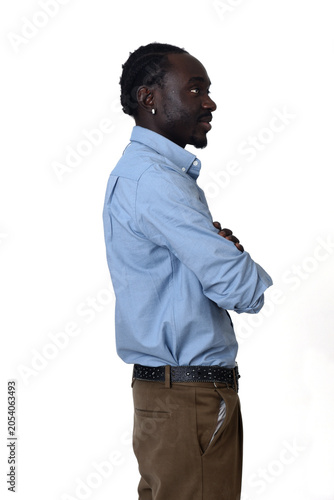 side view of  waist up portrait of a african man arms crossed