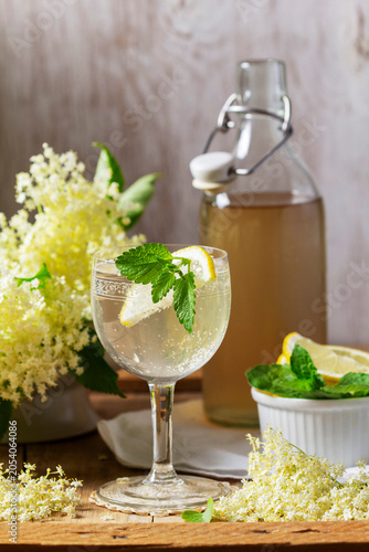 Sparkling Elderflower Drink with Lemon Mint and Homemade Cordial in Glass Bottle