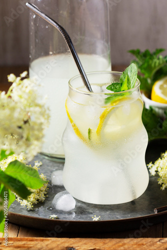 Elderflower Cordial Ingredients with Fresh Blossoms Lemon Sugar and Water on Rustic Table