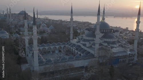 Drone view of the Blue Mosque in Istanbul at sunset. The iconic Ottoman landmark dominates the historic skyline overlooking the Bosphorus.