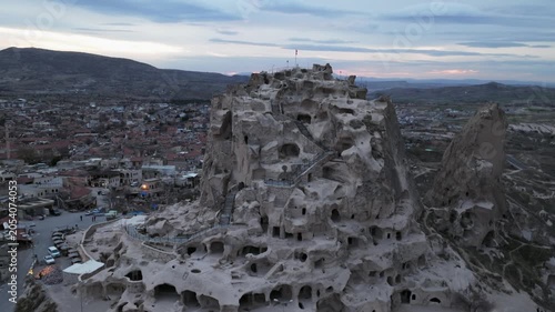 Drone view of Ortahisar Castle towering above the historic town of Ortahisar in Cappadocia, Turkey. A remarkable example of rock-carved architecture.