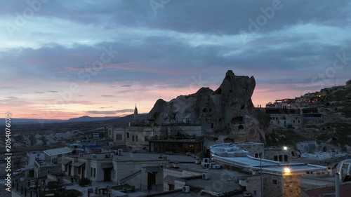 Drone view of Ortahisar Castle towering above the historic town of Ortahisar in Cappadocia, Turkey. A remarkable example of rock-carved architecture.