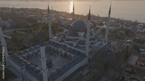 Drone view of the Blue Mosque in Istanbul at sunset. The iconic Ottoman landmark dominates the historic skyline overlooking the Bosphorus.