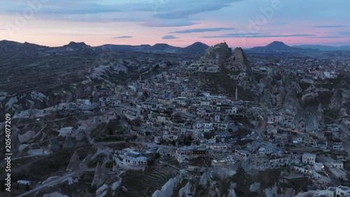 Drone view of Ortahisar Castle towering above the historic town of Ortahisar in Cappadocia, Turkey. A remarkable example of rock-carved architecture.
