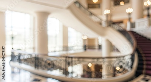 Blurred Abstract Background of Modern Hotel Lobby Interior with Grand Staircase.