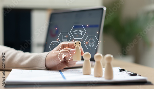 Obraz na płótnie Employee training and professional development concept with wooden figures, digital learning icons and laptop