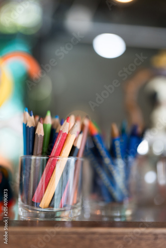 Multicolored or colorful pencils in glass cup. Back to School Concept. Perfect for art and creative endeavors