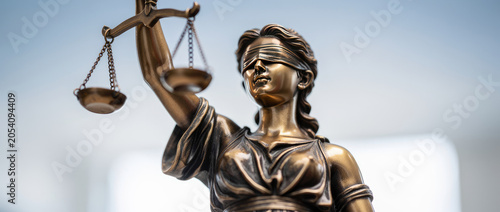 The Statue of Justice Holding Scales of Justice Blindfolded Symbolizing Law and Fairness.