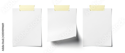 Three blank white sticky notes attached with yellow tape on a white background.