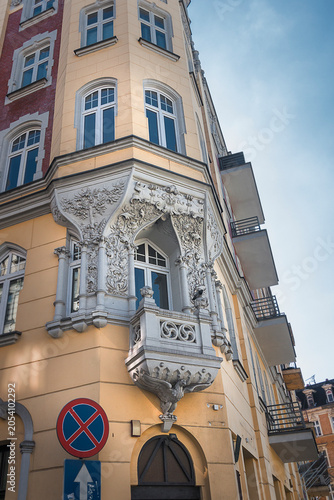Detail of an old house. Close-up of a balcony with decoration and sculpture. Architecture in Katowice, Poland