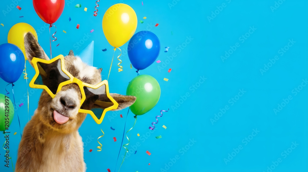 Naklejka premium Funny Baby Goat Wearing Star Glasses and Party Hat with Colorful Balloons on Blue Background