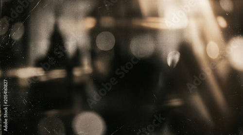 Blurry city night bokeh with vintage film scratches texture.