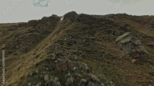 The Fpv drone climbs up along the cliffs and notices a large herd of mountain goats. High quality 4k footage